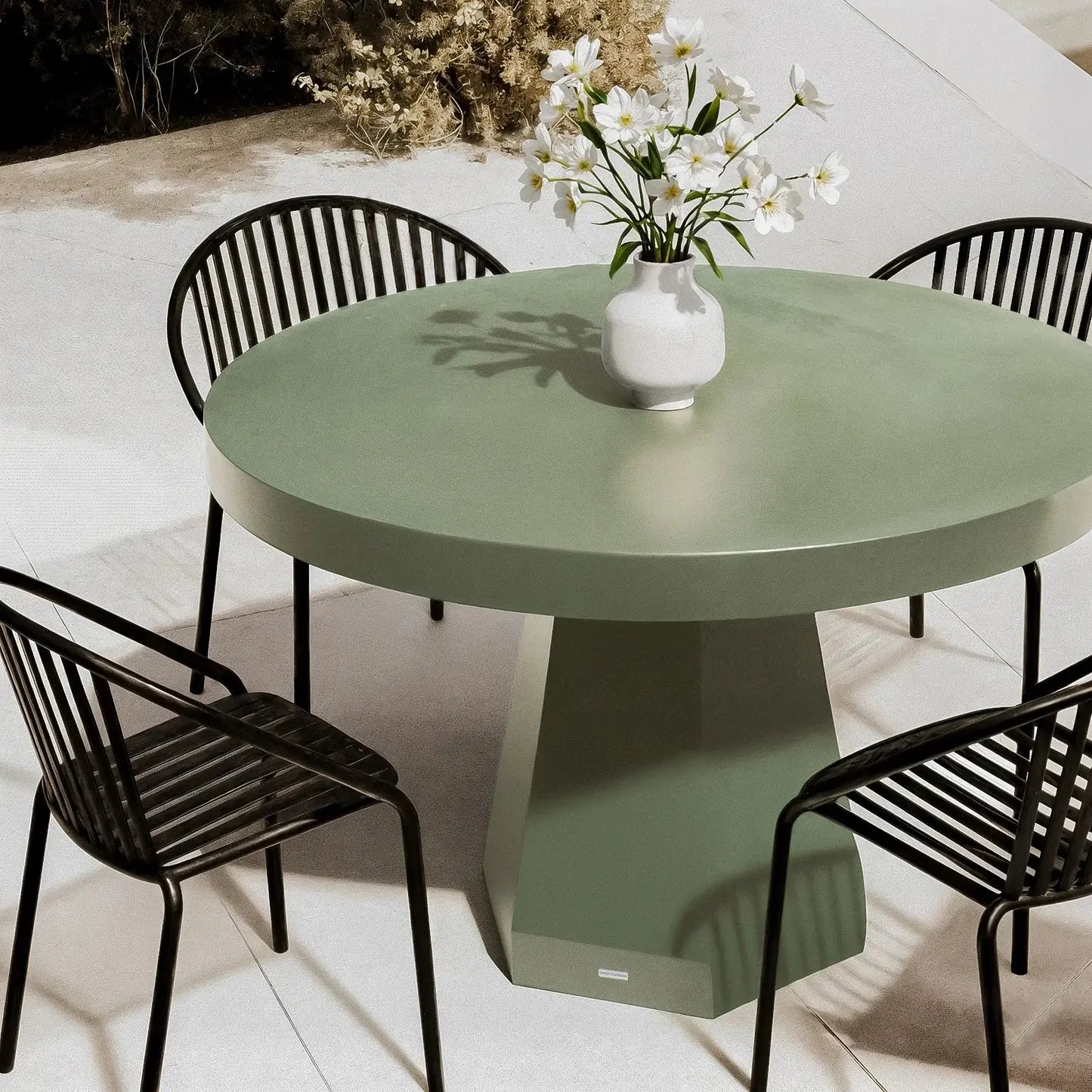 modern concrete outdoor dining table beyond living