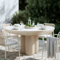 modern round concrete outdoor dining table beyond living