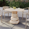 modern round concrete outdoor dining table beyond living